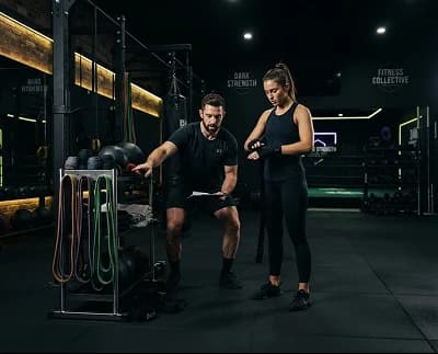 Trainer checking equipment with athlete